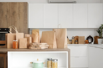 Paper bags with juice on table in kitchen. Food delivery service