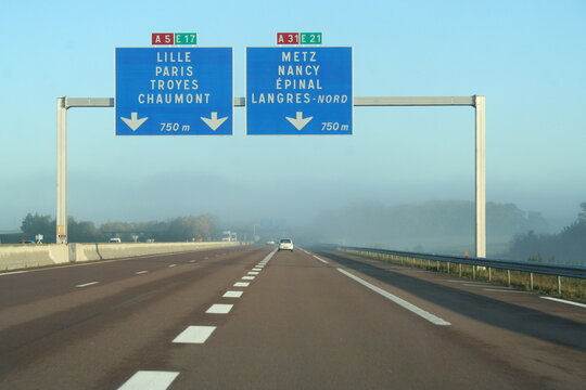 motorway signs in France above a misty freeway - panneaux autoroutiers en France au dessus d'une autoroute embrumm&eacute;e