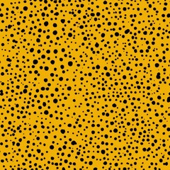 Abstract pattern of  black dots on mustard yellow.