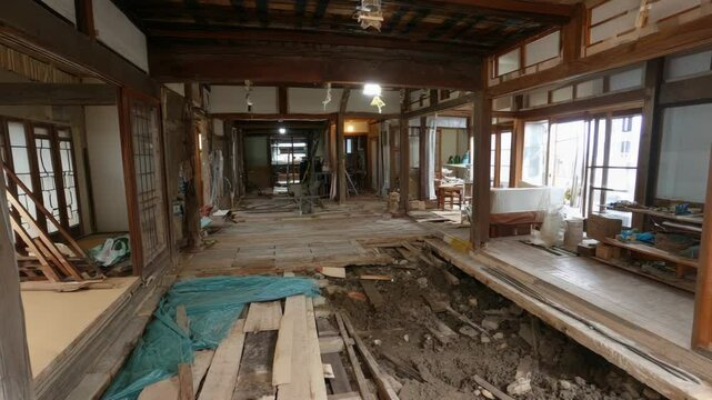Demolished traditional house interior shows exposed floorboards and supports during renovation project in an old home
