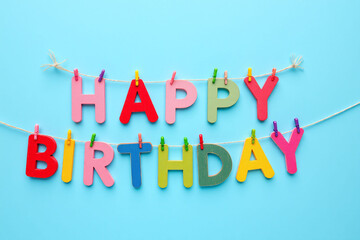 happy birthday banner hanging on a clothes line