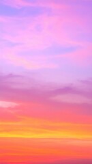 Fototapeta premium A breathtaking sunset paints the sky in vibrant hues of orange, pink, and purple, as fluffy clouds drift lazily, illuminated by the golden sun sinking below the horizon.