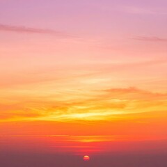 Obraz premium A breathtaking sunset casts vibrant hues of orange and pink across the rugged mountain range in southern China, silhouetting the peaks against the glowing sky.