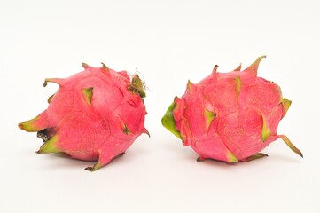 two whole dragon fruit isolated on white background, full depth of field, copy space