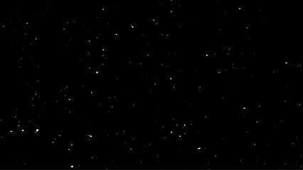 Real falling snow on a black background for use as a texture layer in a photo design. Snowstorm on a black background. 