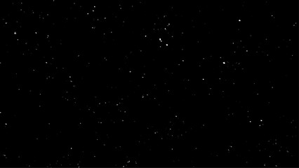 Real falling snow on a black background for use as a texture layer in a photo design. Snowstorm on a black background. 