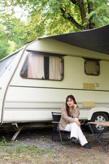 Young woman camping in rv car while traveling