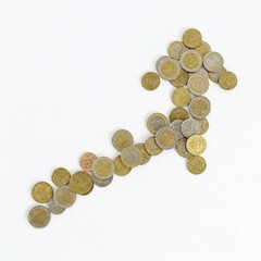 Upward arrow made of assorted coins on white background