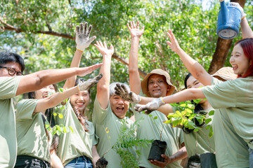 Happy Volunteers Team Celebrating Outdoors, Group of Happy Asian Volunteers Team in Park for Charity Event with Joining Hands