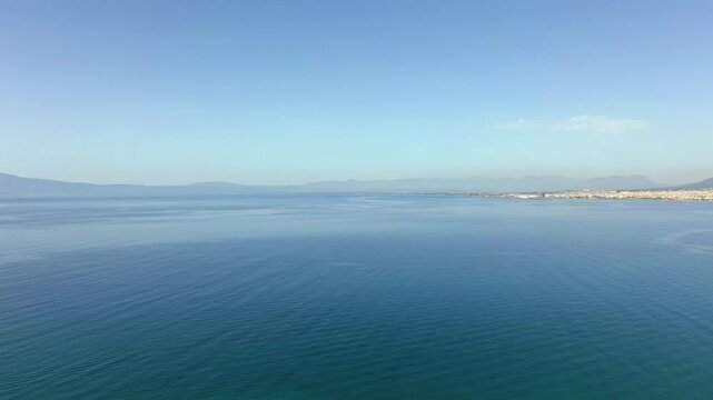 Aerial wide panoramic view of deep blue sea of Kalamata bay, revealing Verga beach at foot of Taigetos mountain 4K