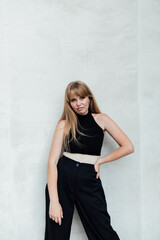 Fototapeta premium female student in black street clothes walking around the city