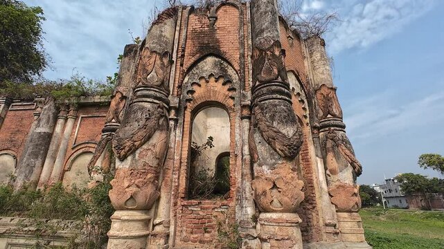 Ancient palace ruins with intricate carvings and weathered brick architecture overgrown with vegetation, Rajnagar palatial complex, Rajnagar, Bihar, India