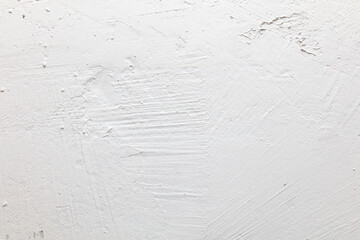 A white wall with a rough texture
