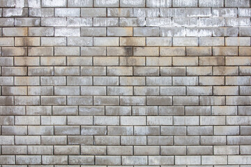 A brick wall with a grey color