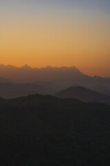 nature traveling with orange sky and layer of mountain with sunrise background