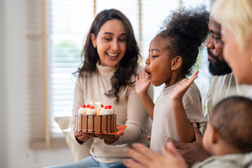 African love big family celebrating birthday party, mother holding cake for daughter, father, aunt and baby singing happy birthday, joyful moment, candles, surprise, special day and happiness at home