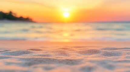 Obraz premium Soft sand glows under the golden rays of the setting sun, reflecting hues of orange and pink over the tranquil ocean waters