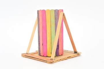 children's craft Arranged wooden ice cream sticks stuck with glue isolated on white , concept of DIY and kid's creativity and hobby