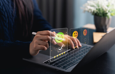 Close-up hand woman interacts with a laptop to express feedback using emotion icons and star...