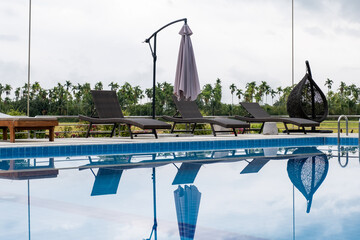 Sun bed chair on the edge of a hotel or resort swimming pool