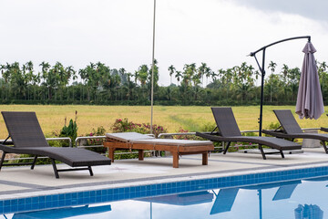 Sun bed chair on the edge of a hotel or resort swimming pool