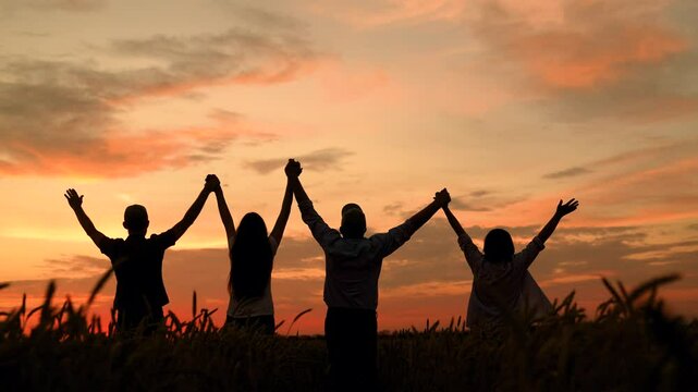 Group farmers teamwork, business group, wheat field harvest, sun. Business people united by one idea. Happy team people holding hands raise hands. Teamwork people. Partnership help in business concept