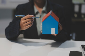 Real estate agents explain models of housing estates in projects to elaborate to clients,...