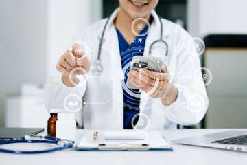 medical technology concept,smart doctor hand working with modern laptop computer virtual icon...