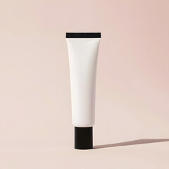 Minimalist Beauty Product: A clean and modern aesthetic of a white squeeze tube with black cap on soft pink background.  Perfect for showcasing your beauty or skincare brand's products.