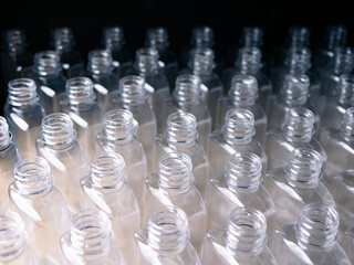 Close up Row of plastic drink water bottles for filling process.