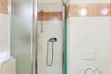 Modern bathroom with glass shower enclosure and tiled walls