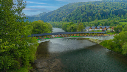 The pedestrian and bicycle bridge known as the &ldquo;Broken Bridge&rdquo; spanning the Dunajec River in the picturesque Pieniny Mountains, close to the town of Kroscienko, Poland.