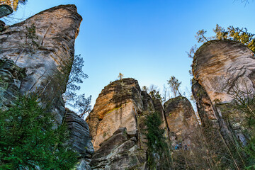 Majestic rock formations and lush forest under clear blue sky