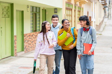 Latino high school students walking and talking in the street