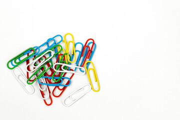 Paper clips on the left side of a white background. Banner with school, office supplies