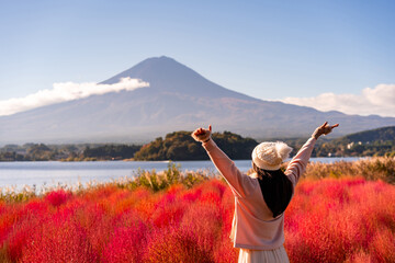 Young female tourist relaxing and enjoying at beautiful landscape mount Fuji at Kawaguchiko Lake