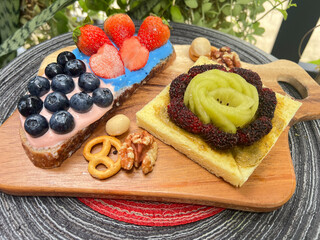 Pink and blue yoghurt toast with strawberry and blueberry and Kiwi fruit matcha peanut butter toast 