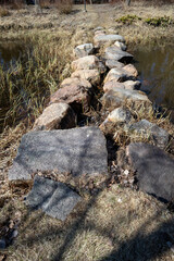stepping stones crossing the water in springtime