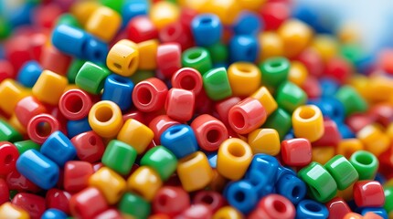 Close-up of colorful plastic pony beads in vivid red, yellow, green, blue, and orange tones, ideal for crafting, DIY jewelry projects, or playful creative design concepts

