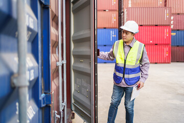 Customs clearance officer or shipyard engineer is inspects against the import - export cargo containers.
