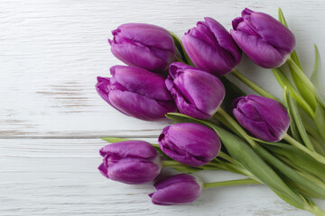 Obraz premium A bouquet of eight vibrant purple tulips rests on a rustic white wooden surface, showcasing their dewy petals and lush green stems. : Generative AI