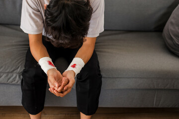 Depressed Young Man With Bandage On His Hand From Suicide Attempt