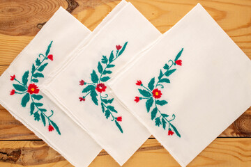 Fototapeta premium Linen home napkins with embroidery made at home, close-up, top view.