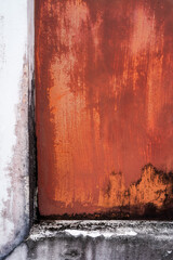 Old white and orange-brown painted concrete walls
