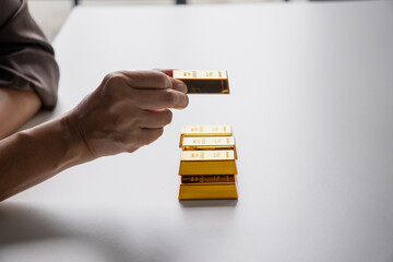 Elderly Asian woman plans retirement, invests in gold bars