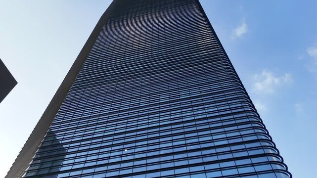 Dramatic Upward View of a Modern Glass Skyscraper

