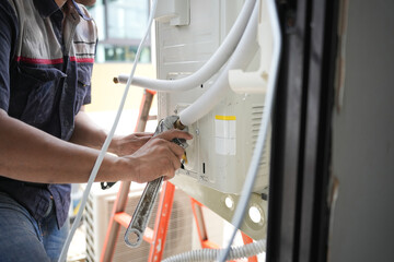 Close-Up of HVAC Maintenance and Repair Work, Professional Air Conditioner Installation or Service in Progress, Technician Repairing Outdoor Air Conditioning Unit with Wrench