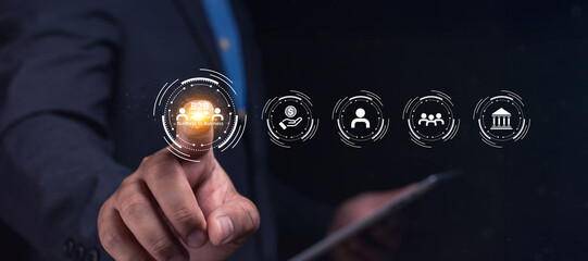 A man in a suit interacts with digital icons representing business and technology on a virtual...