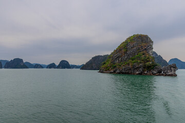 Halong Ha Long Bay Hanoi this Vietnamese wonder is littered with mountains and Rock cliffs popping out of the ocean, lush green mountains in Vietnam