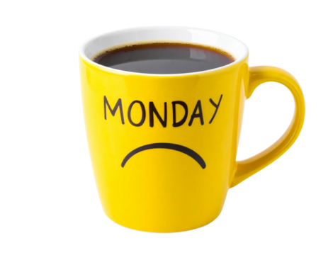 A yellow mug filled with coffee features the word "MONDAY" and a sad face illustration.